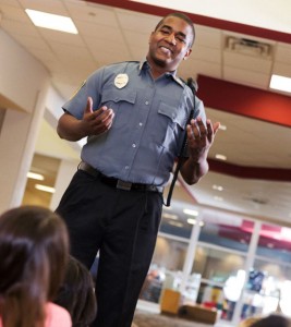 Police officer chatting with students about preventing school shootings